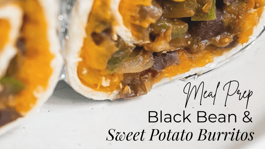 Meal Prep Black Bean & Sweet Potato Burritos is written in the bottom right corner in various fonts. The photo is zoomed into the black bean and sweet potato burrito rolled up and cut in half.